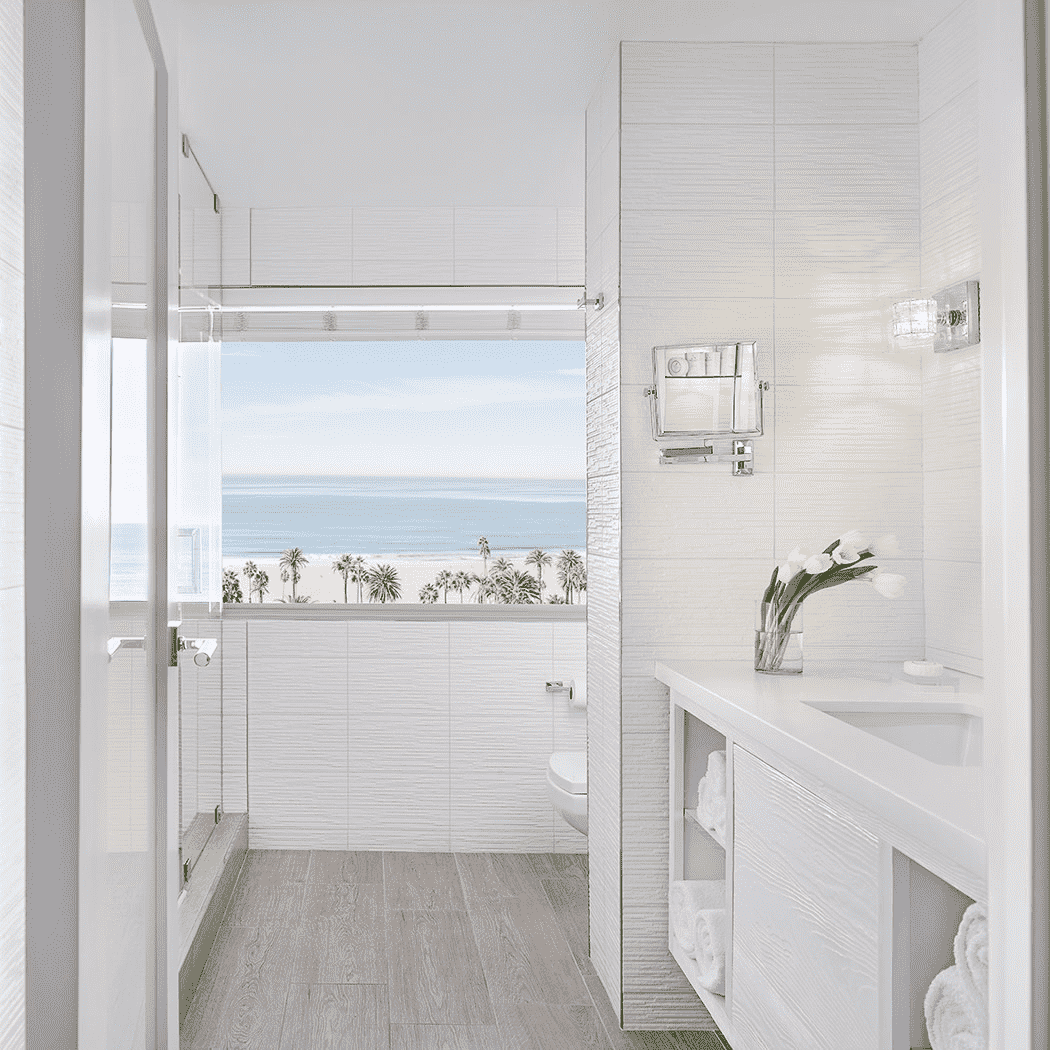 all white bathroom with view of ocean