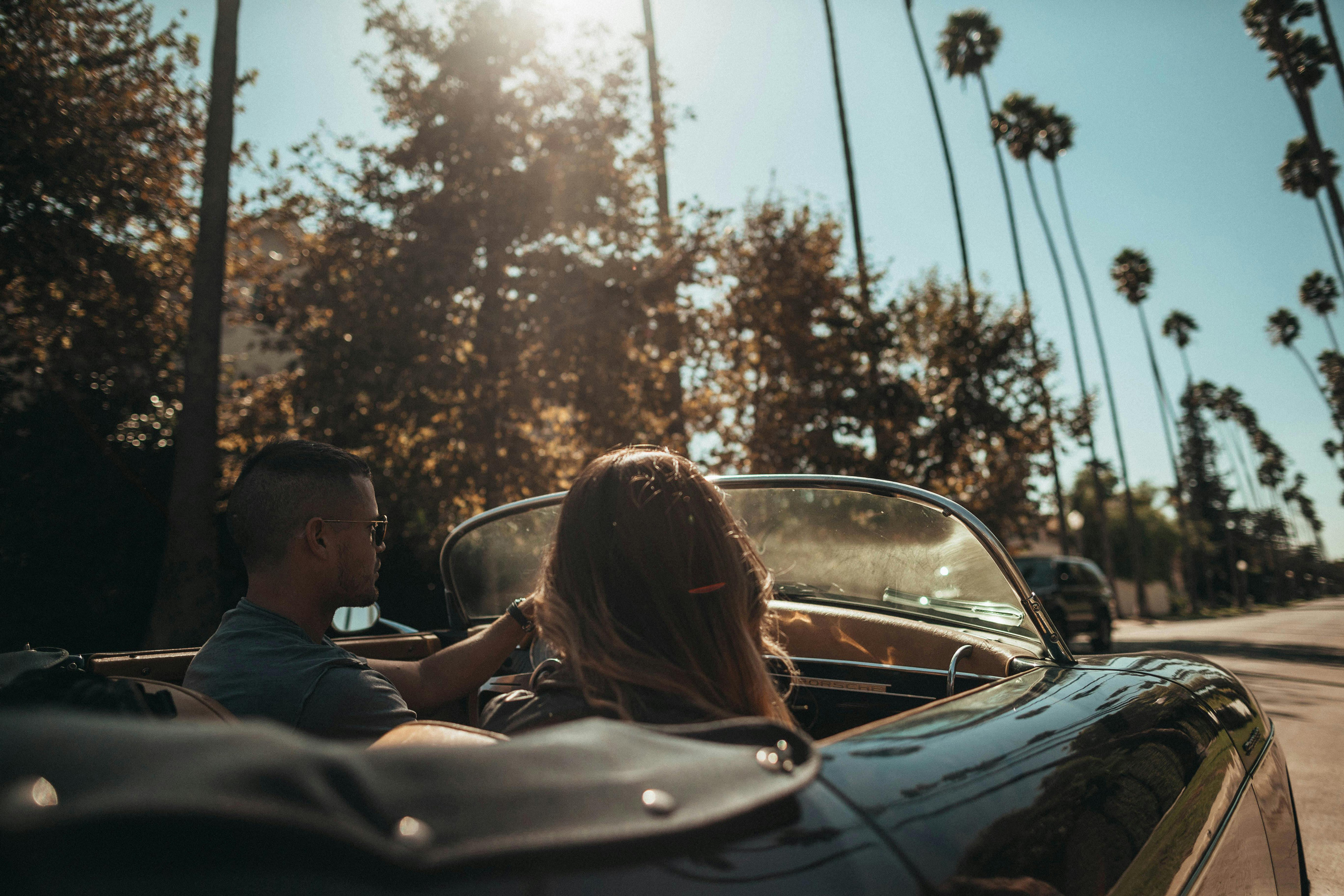 two people driving in Beverly Hills in a convertible