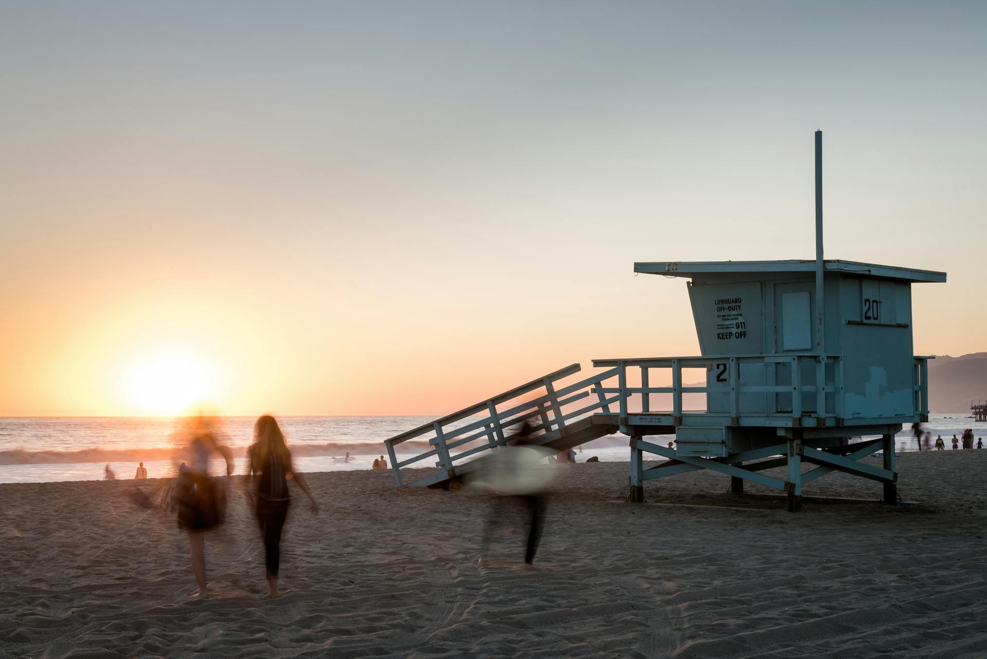 lifeguard stand on a beach at sunset