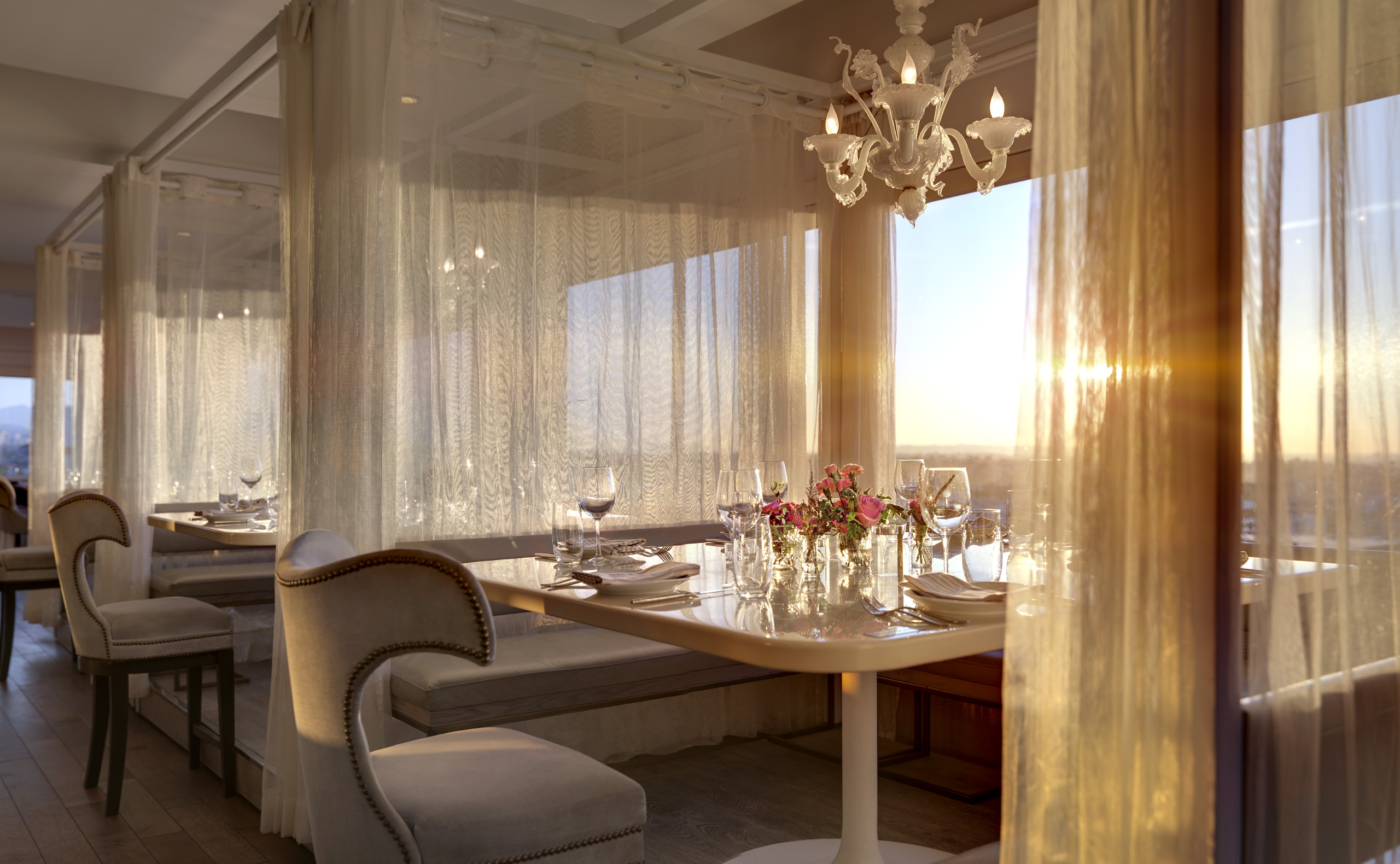 sunset view of a set table at penthouse