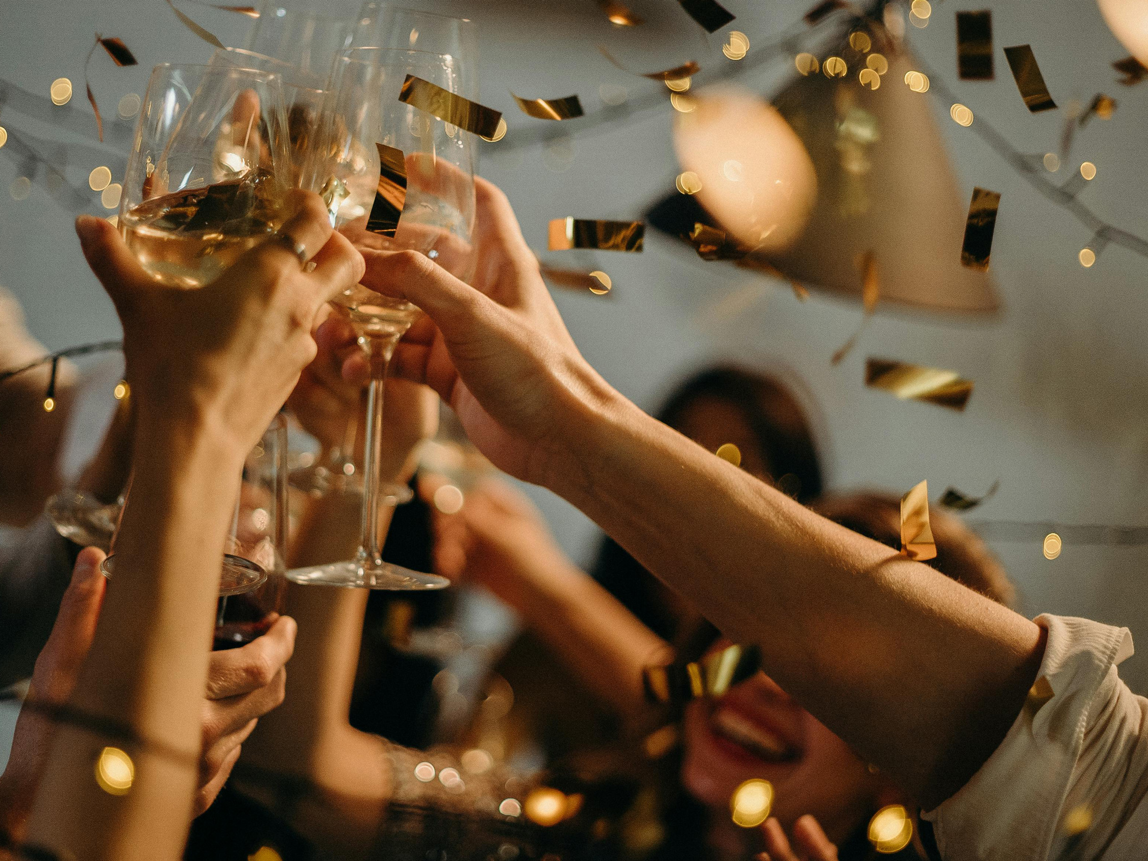 a toast at a party with gold confetti