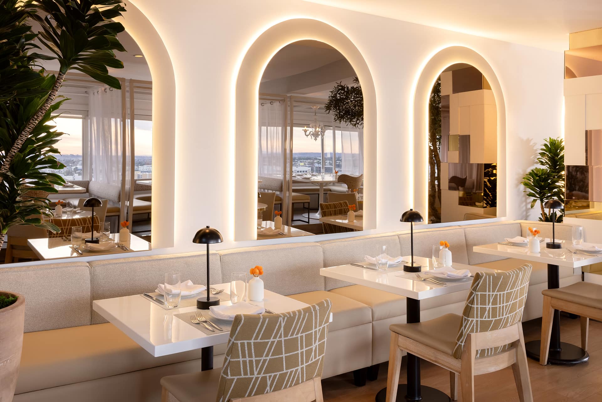 Elegant restaurant interior with glowing arches and cozy seating.