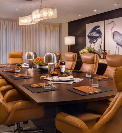 Sophisticated boardroom with leather chairs and elegant lighting.