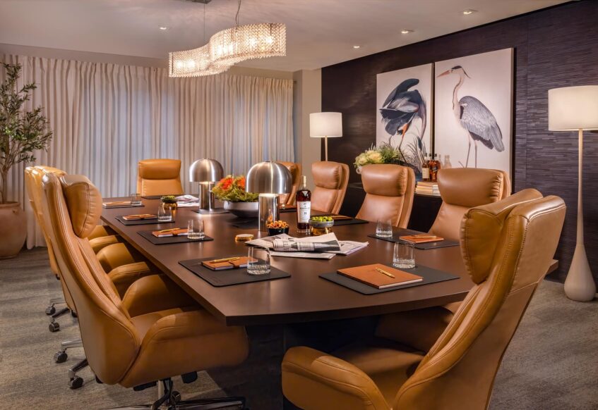 Sophisticated boardroom with leather chairs and elegant lighting.