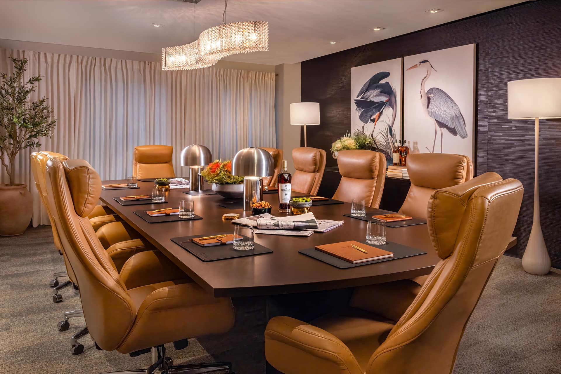 Sophisticated boardroom with leather chairs and elegant lighting.
