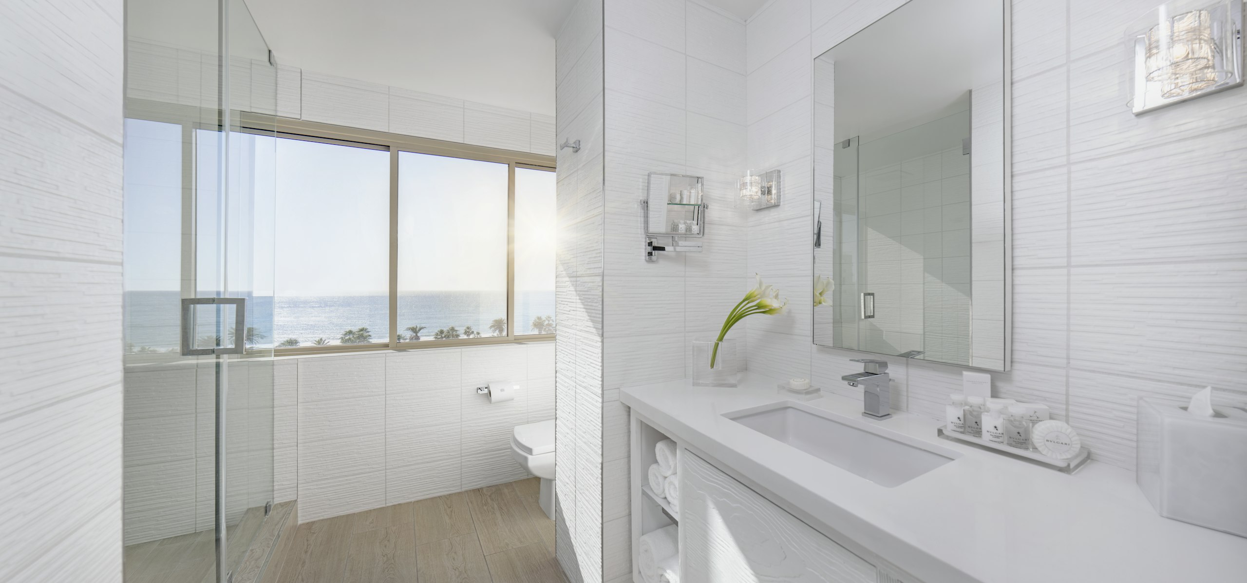 Luxurious bathroom with ocean views and white finishes.
