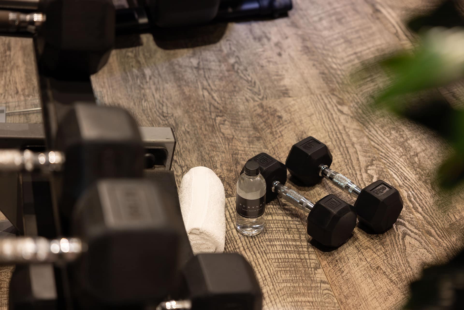 Dumbbells and water on gym floor