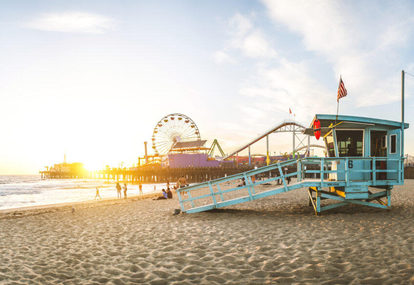 Lifeguard tower and pier at sunny beach.