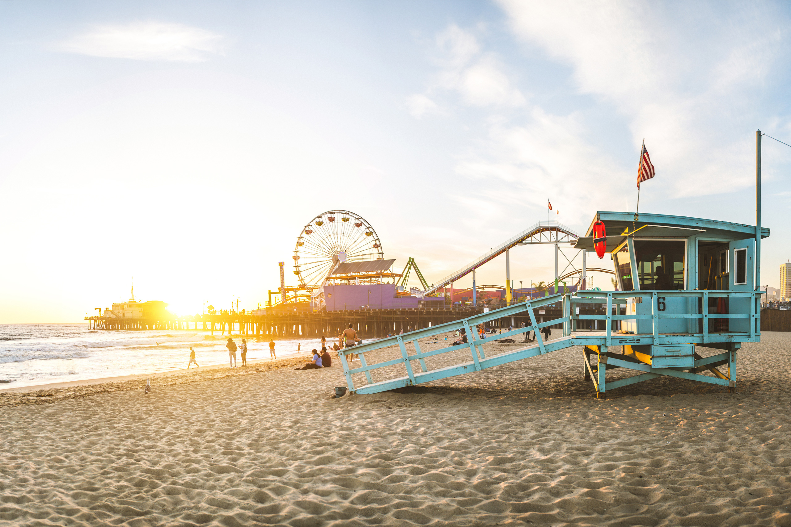 Lifeguard tower and pier at sunny beach.