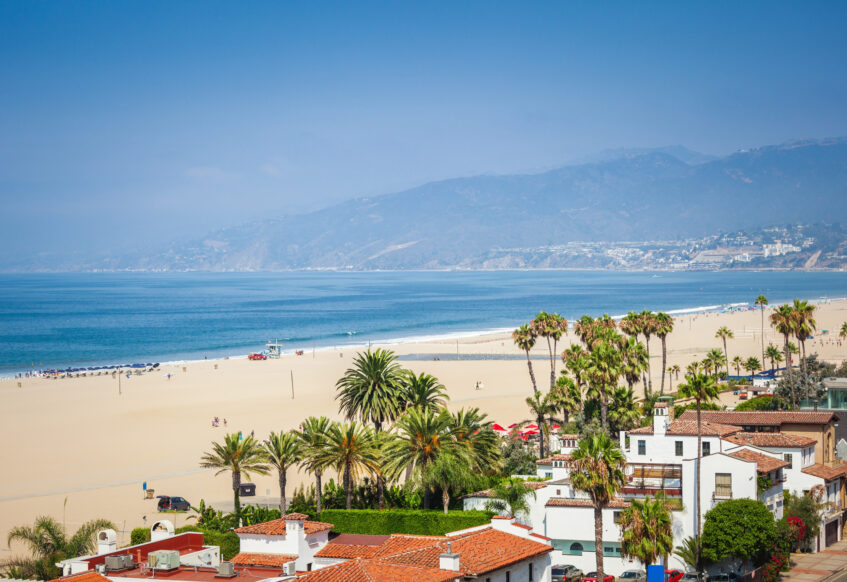 Coastal view of beach, ocean, and hillside homes.