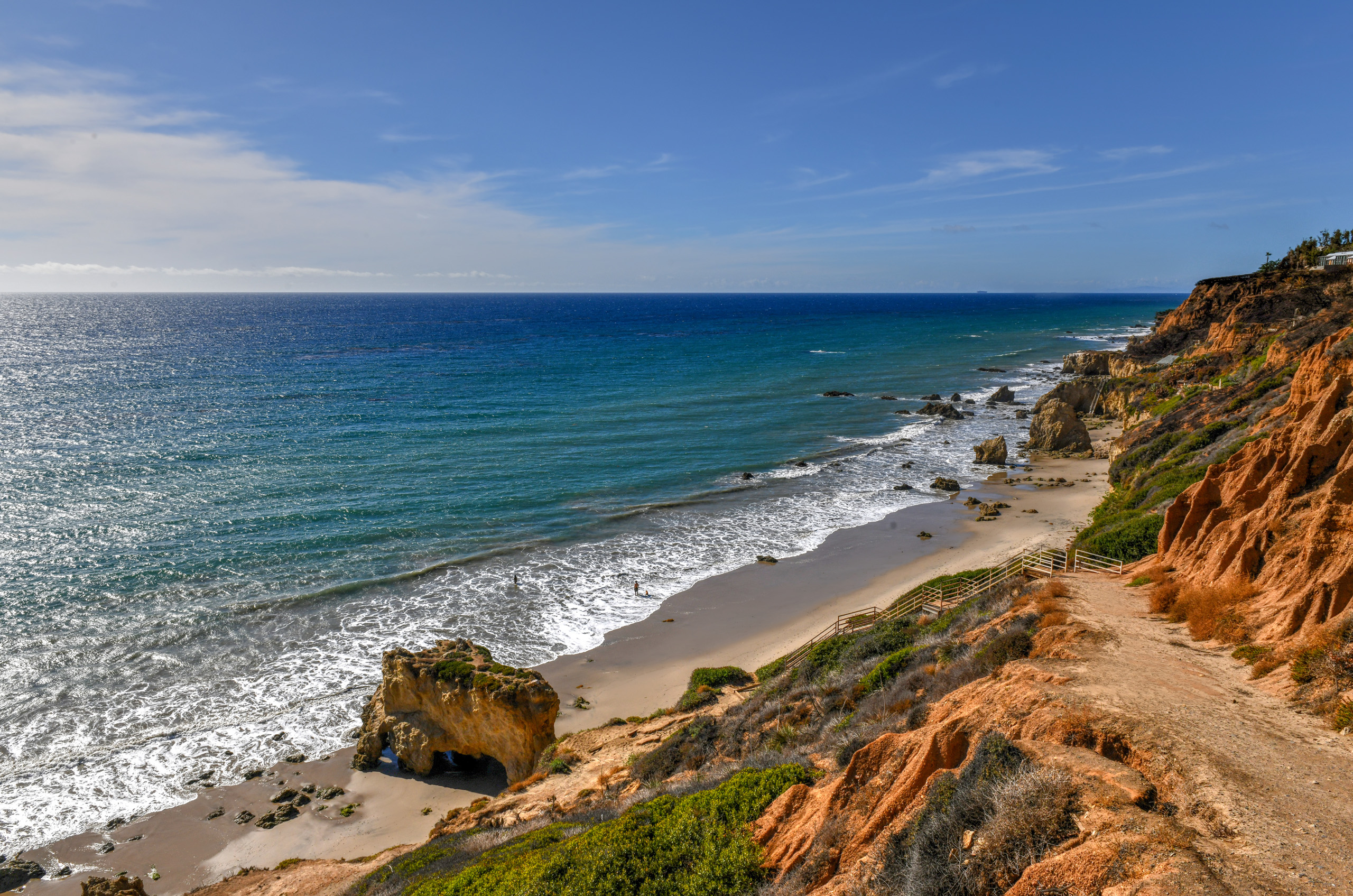 Scenic coastal cliffs and beach along Malibu shoreline.