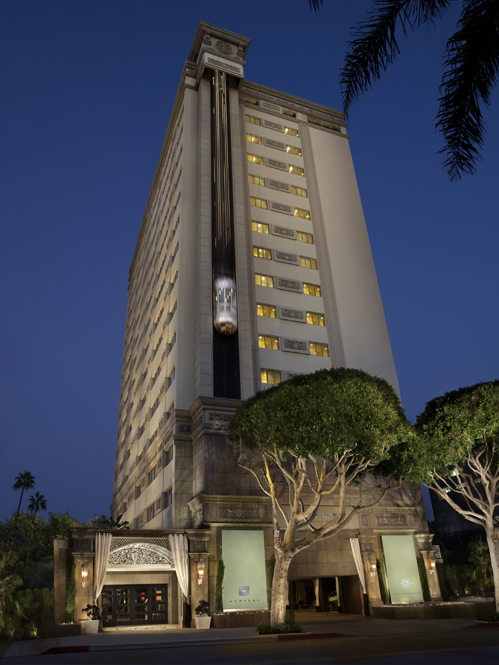 Luxury hotel exterior at night with illuminated windows